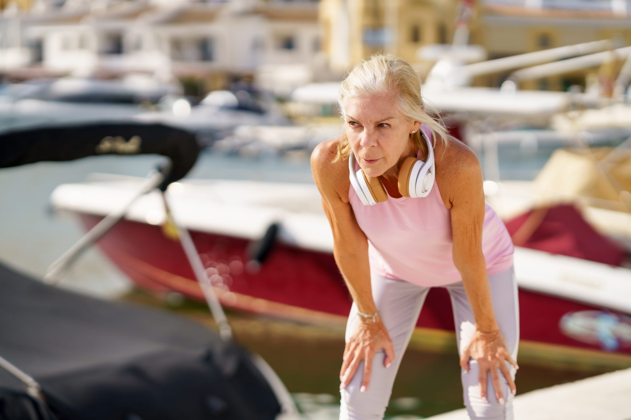 Mature sportswoman takes a break from running